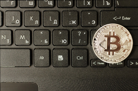Silver bitcoin on keyboardの写真素材
