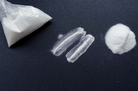 Two lines of cocaine on black backgroundの写真素材