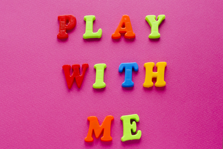 text "play with me" on pink backgroundの写真素材