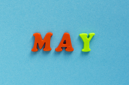 word "may" of plastic magnetic letters on blue backgroundの写真素材