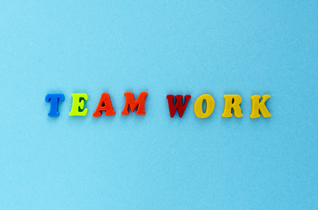 text" team work" of plastic magnetic letters on blue backgroundの写真素材