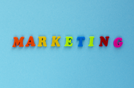 word "marketing" of plastic magnetic letters on blue backgroundの写真素材