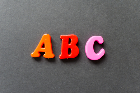 letters "abc" of plastic magnetic letters on grey backgroundの写真素材