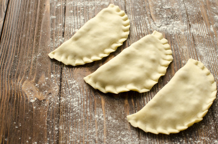 Traditional crimean tatar dish- cheburek on wooden background is ready to fryの写真素材