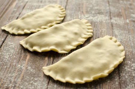 Traditional crimean tatar dish- cheburek on wooden background is ready to fryの写真素材