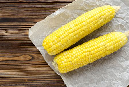 grilled corncob on wooden backgroundの写真素材