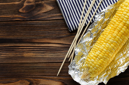 Grilled corncob on wooden backgroundの写真素材