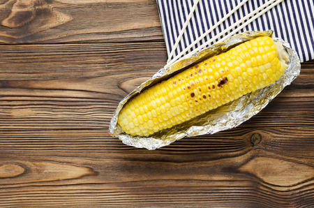 Grilled corncob on wooden backgroundの写真素材