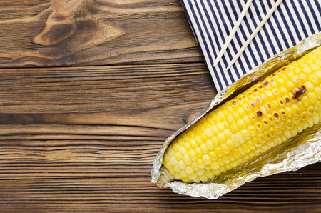 grilled corncob on wooden backgroundの写真素材