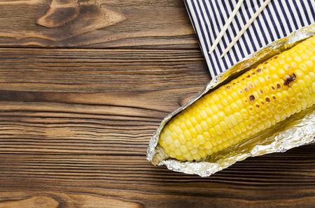 grilled corncob on wooden backgroundの写真素材