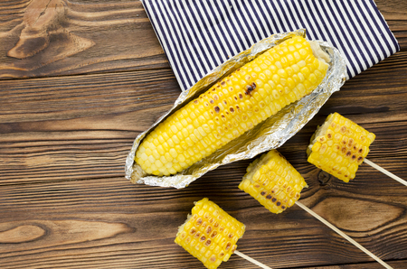 grilled corncob on wooden backgroundの写真素材
