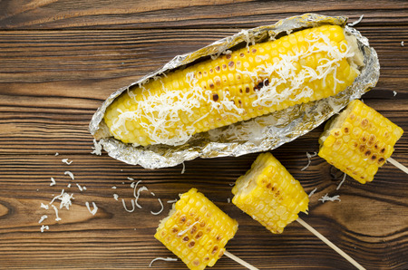 grilled corncob on wooden backgroundの写真素材