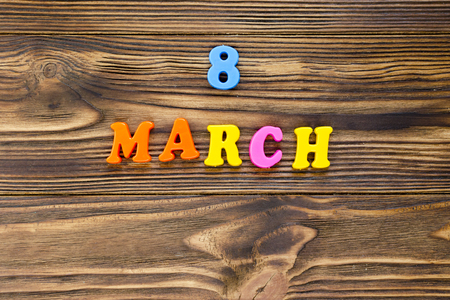 text "8 march"  of plastic magnetic letters on wooden backgroundの写真素材