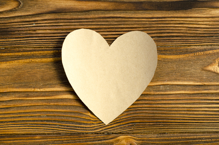 kraft paper heart on wooden backgroundの写真素材