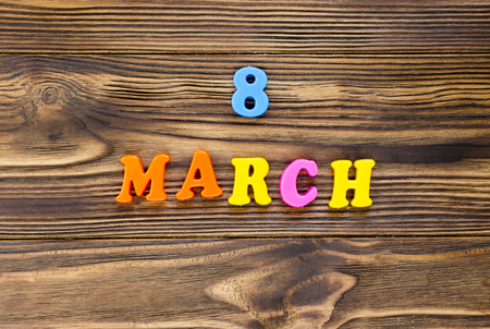 text "8 march"  of plastic magnetic letters on wooden backgroundの写真素材