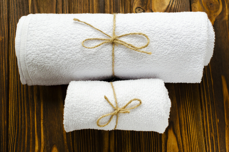 two white towels on wooden backgroundの写真素材
