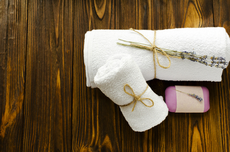 towels, lavender soap, flowers on wooden table. spa treatmentの写真素材