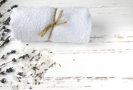 dry lavender flowers with soap, towel and sea salt on vintage wooden table. spa treatmentsの写真素材