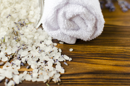 towel and sea salt with lavender on wooden table. spa treatmentの写真素材