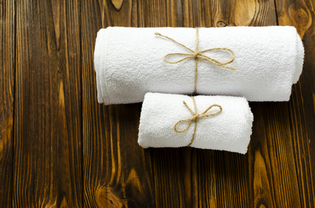 two white towels on wooden backgroundの写真素材