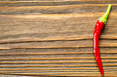 chili pepper on wooden background with copy spaceの写真素材