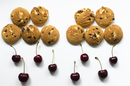 Creative food idea- cookies and cherries look like clouds and rainの写真素材