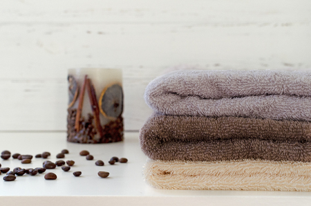 stack of towels, candy, coffee beans on white wooden backgroundの写真素材