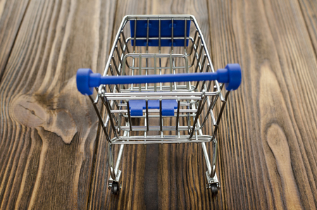 empty shopping cart on wooden backgroundの写真素材