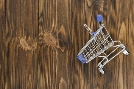 empty shopping cart on wooden backgroundの写真素材
