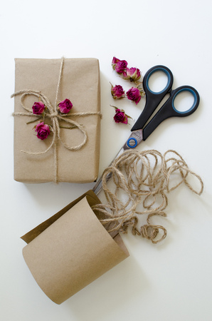 Gift handmade box with craft paper and rope and dry rosesの写真素材
