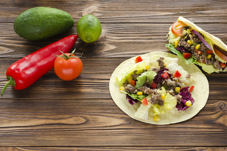tacos  and ingredients on wooden tableの写真素材