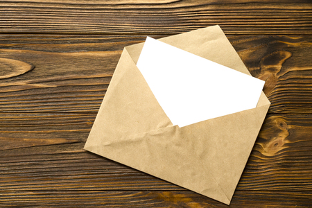 Envelope with card on wooden backgroundの写真素材