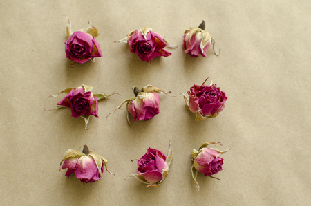Isolated buttons of dried roses on  craft paper backgroundの写真素材