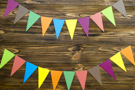 paper  flags  party garland  on wooden backgroundの写真素材