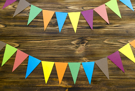paper  flags  party garland  on wooden backgroundの写真素材