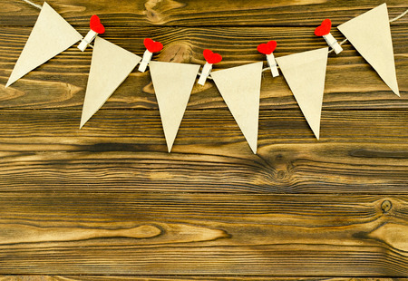 craft paper  flags with decorative pins  party garland  on wooden backgroundの写真素材