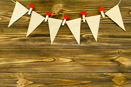 craft paper  flags with decorative pins  party garland  on wooden backgroundの写真素材