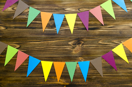 paper  flags  party garland  on wooden backgroundの写真素材