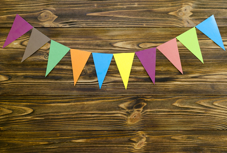 paper  flags  party garland  on wooden backgroundの写真素材