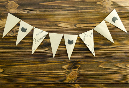 craft paper  flags  party garland  on wooden backgroundの写真素材