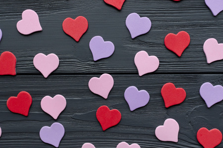 paper colored hearts on grey wooden backgroundの写真素材