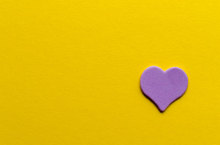 Paper purple heart on yellow backgroundの写真素材