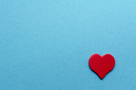 Paper red heart on blue paper backgroundの写真素材