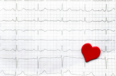 paper cardiogram of young healthy women and red paper red heartの写真素材