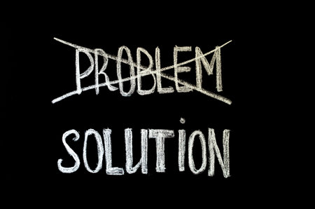 hand writing text 'problem and solution' on chalkboardの写真素材