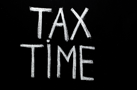  hand written phrase 'tax time' on chalkboardの写真素材