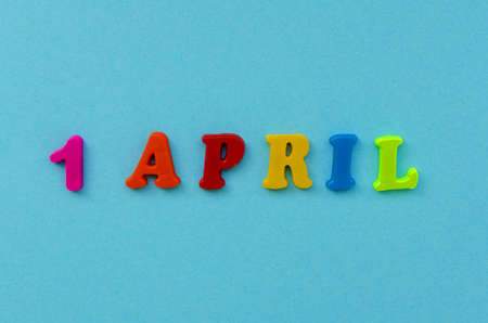 colorful text  '1 april"  of magnetic letters on blue paper backgroundの写真素材