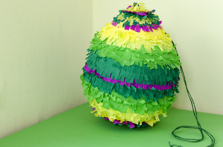 colored paper pinata on white wooden tableの写真素材