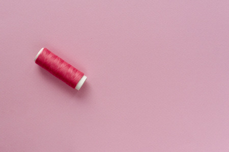 spool of thread on paper backgroundの写真素材