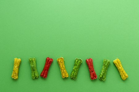 colored chewing bones on greeen backgroundの写真素材